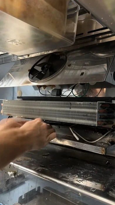 Technician repairing kitchen appliance equipment in a North Abilene home