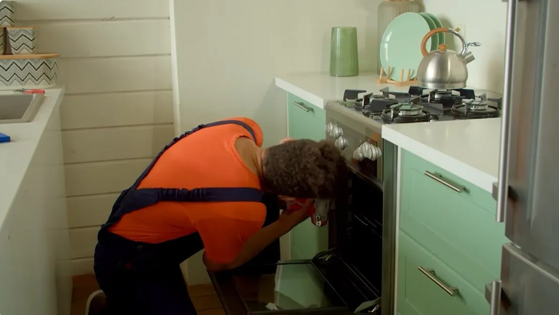 Technician repairing an electric stove